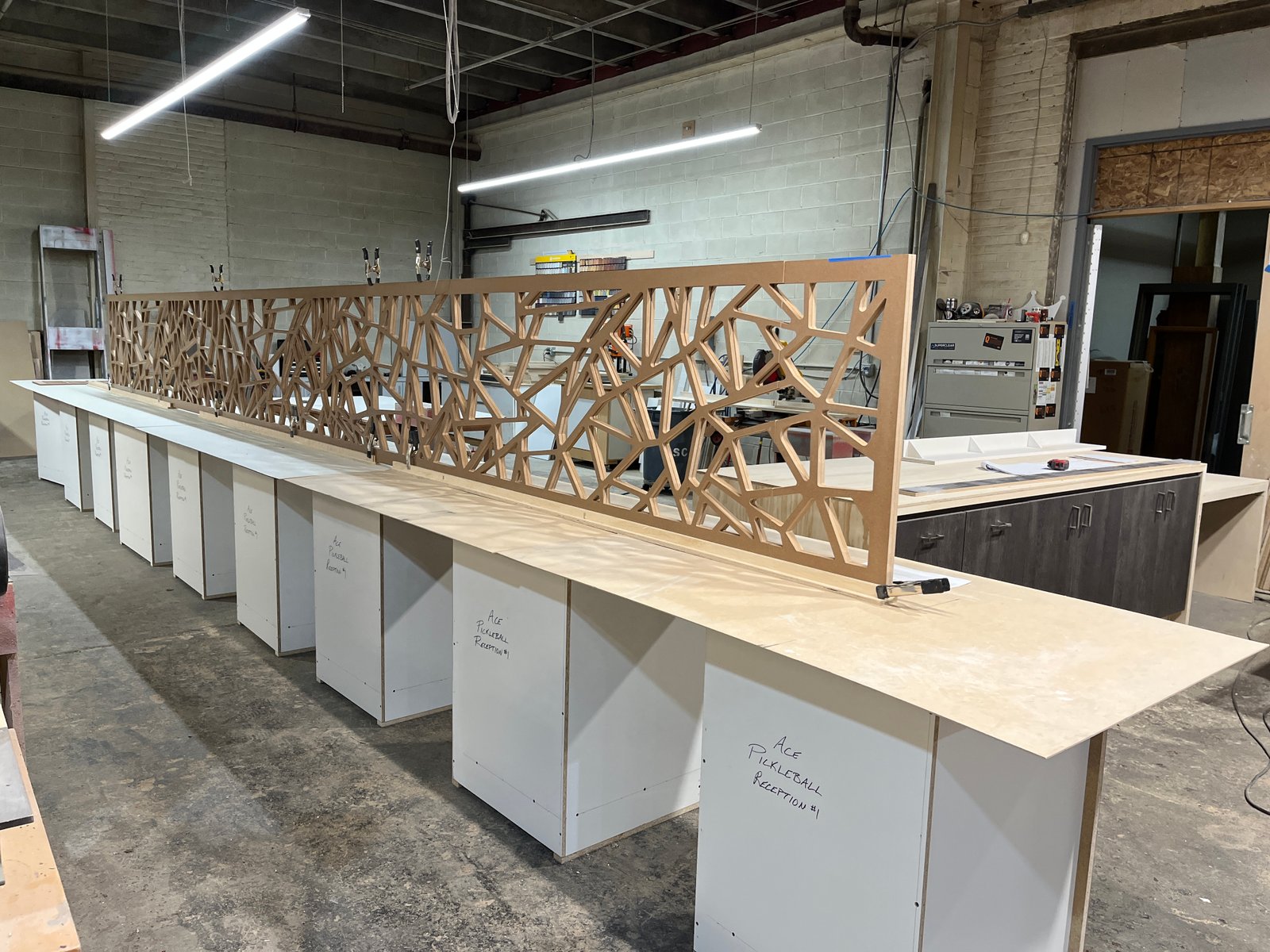 Long CNC geometric panel across counter line