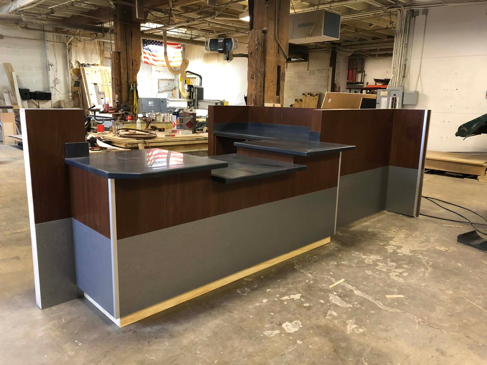 Commercial reception desk with layered counters and clean panel lines