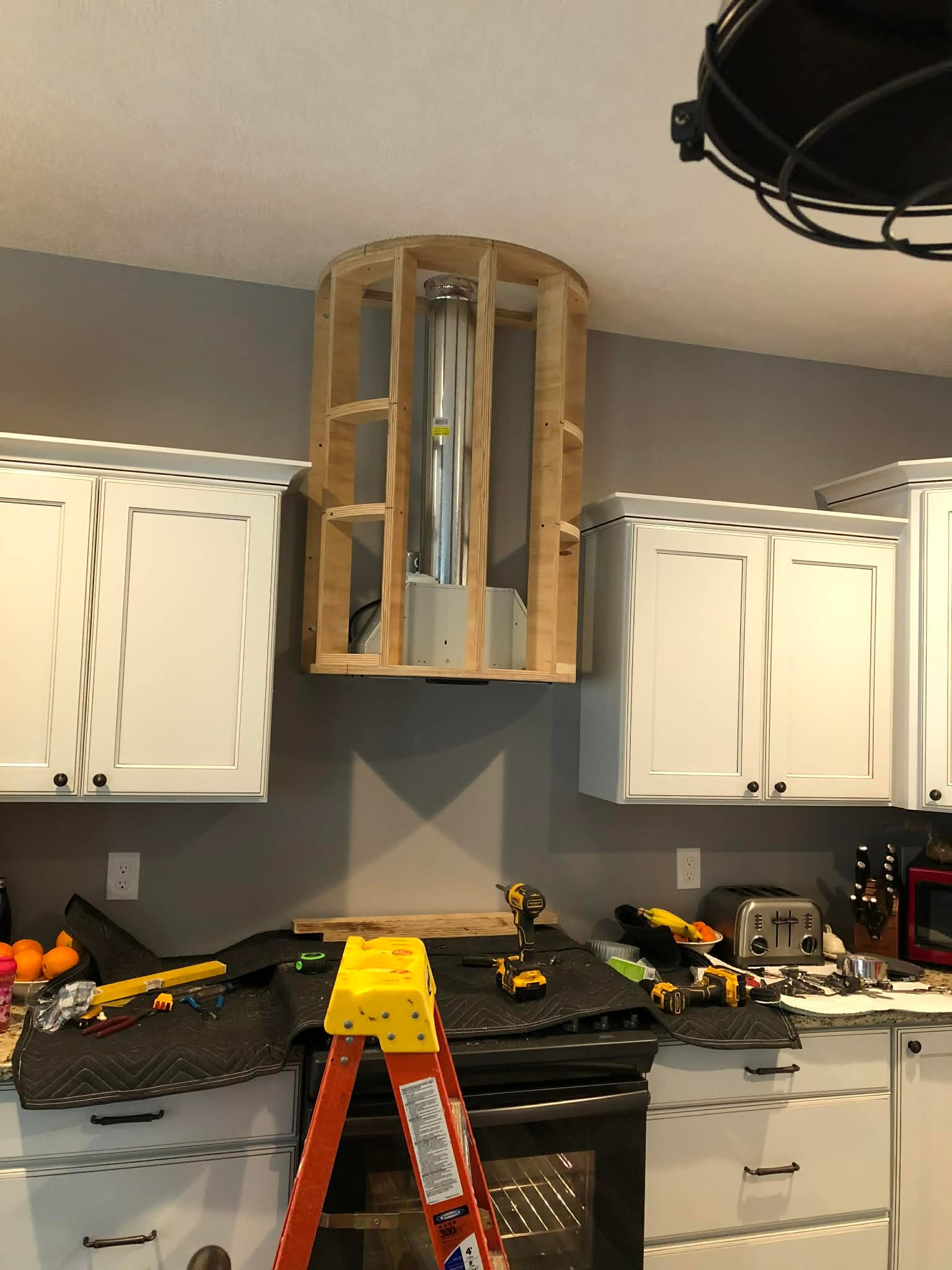 Kitchen range hood build in progress with custom framing and fit-up